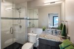 Third bathroom with custom tiled shower